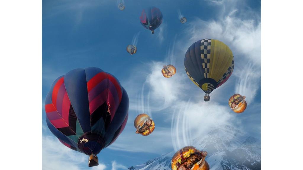 Looking up at numerous hot air balloons