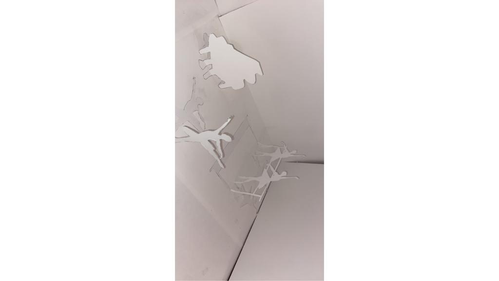 Paper cut out of piano and dancers
