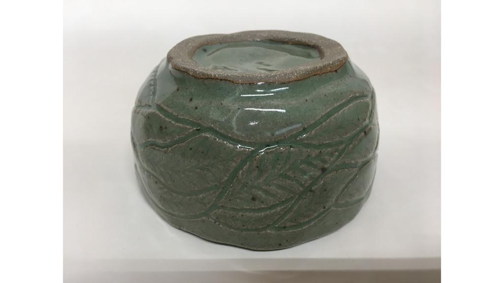 Green clay bowl with leaf etching around side