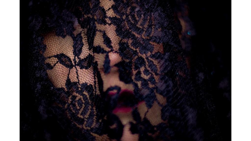 Close up picture of face covered in lace