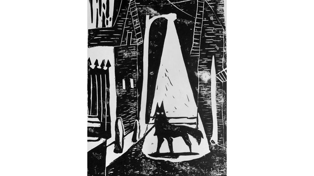 Black and white wolf standing in street light