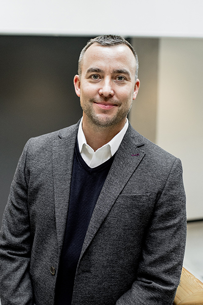 A man in a suit smiling 