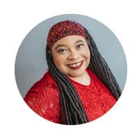 female smiling at camera with red bandana on her head.