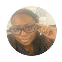 female with glasses with hand on temple