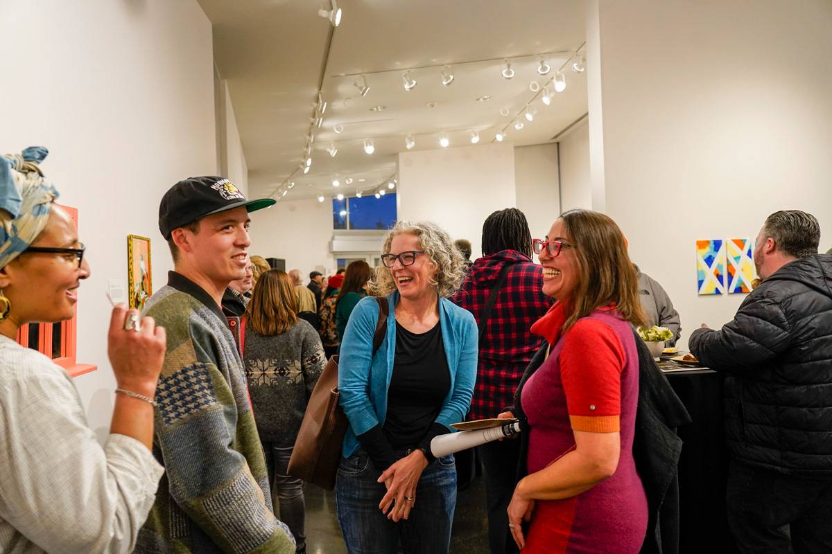 A group of people stand in the TCC art gallery 