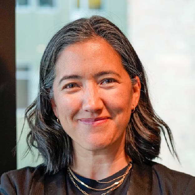 Smiling female with black jacket on.