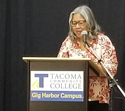 Putsata Reang at the podium of Write in the Harbor for her keynote address.