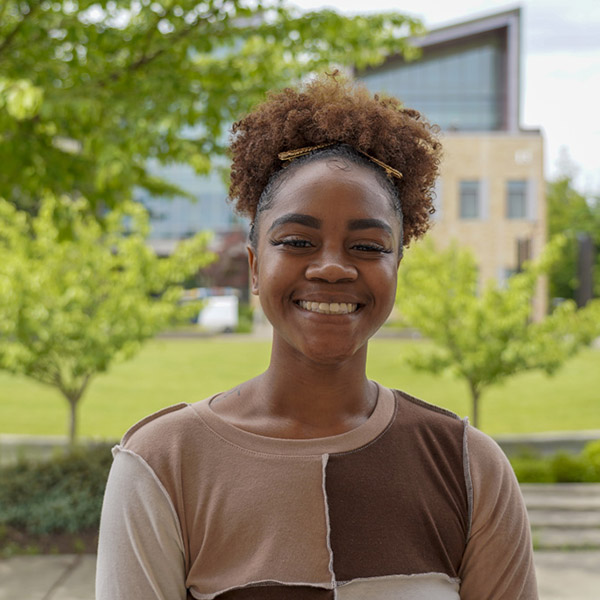 woman with curly hair in top ponytail smiling