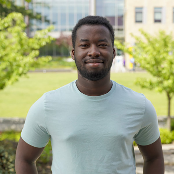 Man in a light green shirt smiling