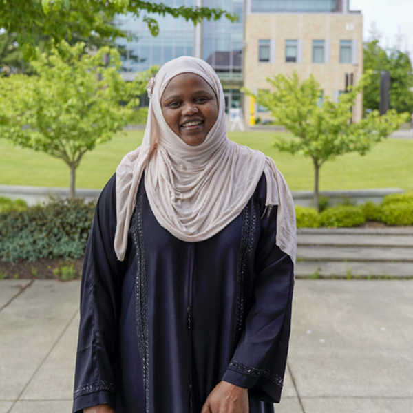 Woman in a headscarf and long dress smiling