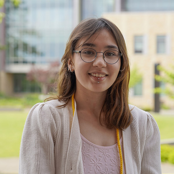 Woman with shoulder length hair and glasses smiling