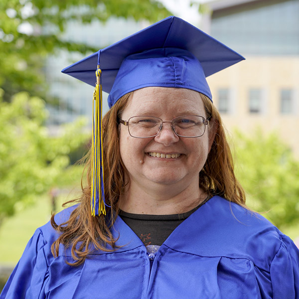 woman in cap and gown smiling