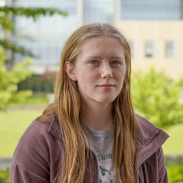 young woman with long hair smiling 