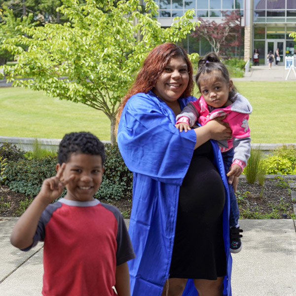 woman and two preschool aged kids smiling