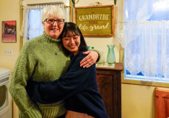 Host hugging student