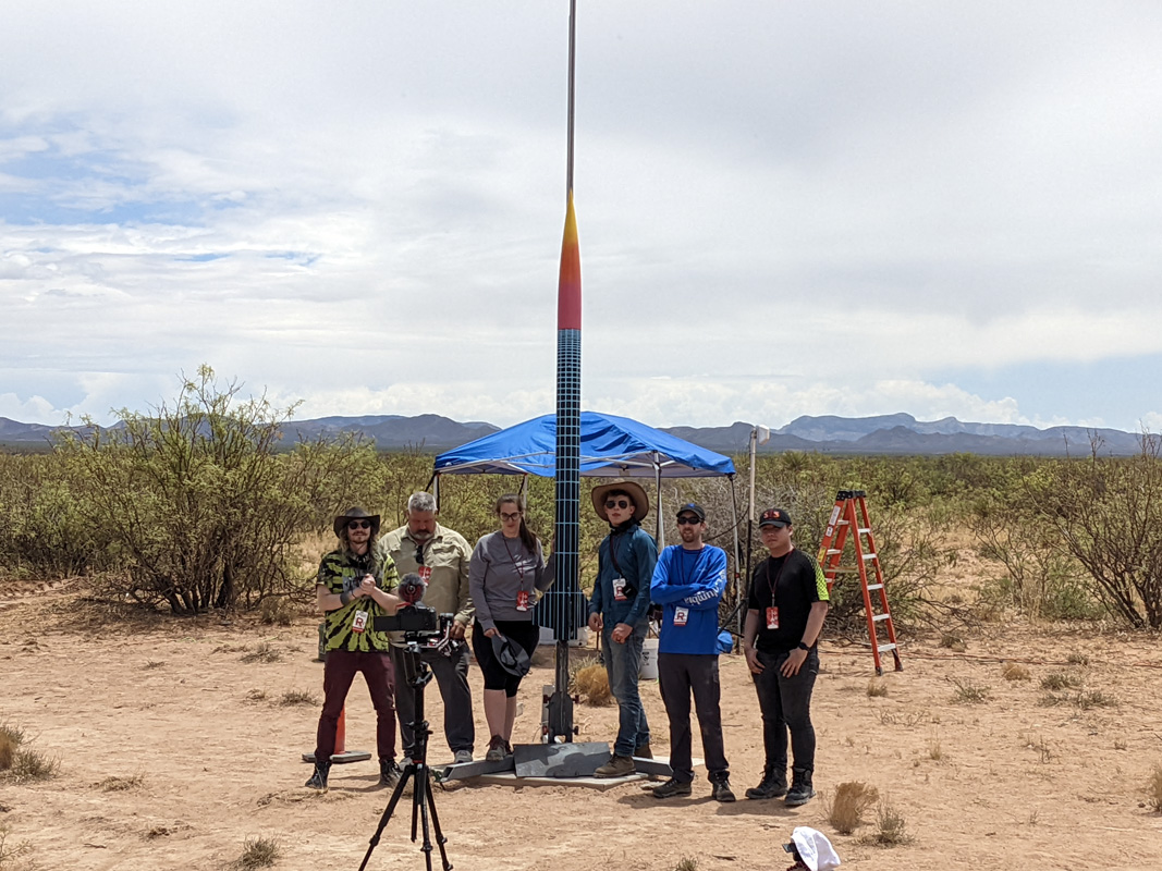 students in the desert with a rocket. 