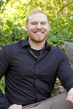 Man with black shirt smiling