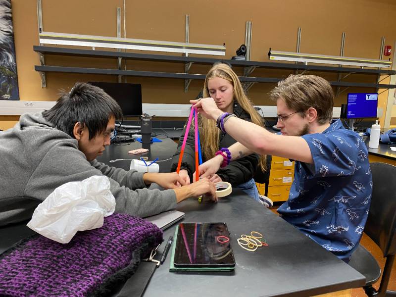 A group of students in an engineering lab: Brown, Lord, and John